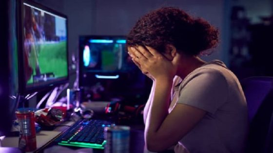 Stressed Teenage Girl Being Bullied Online Whilst Gaming At Home